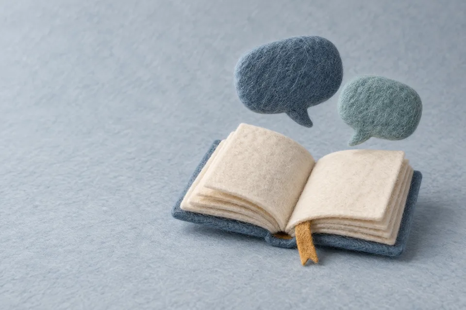 An open wool-felt book and learning conversation bubbles